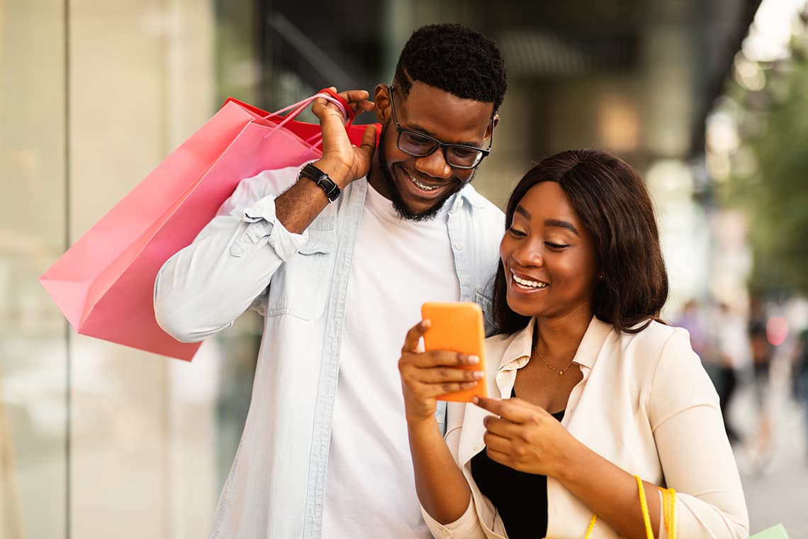 woman and man shopping and looking at phone