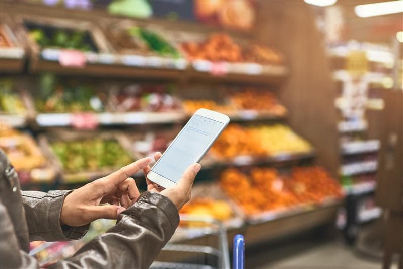 Shopper using coupons to save money on groceries