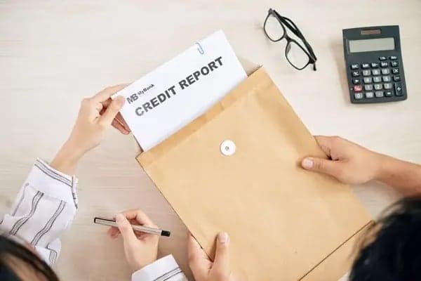 Person reviewing a credit report for signs of fraud