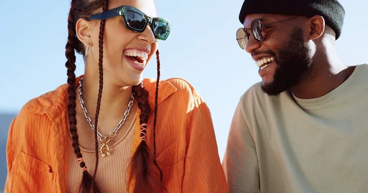 Two people smiling together outdoors