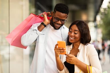 woman and man shopping and looking at phone