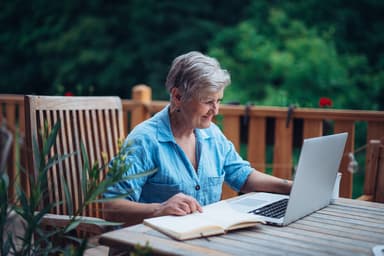 Woman sitting at desk reviewing bills
