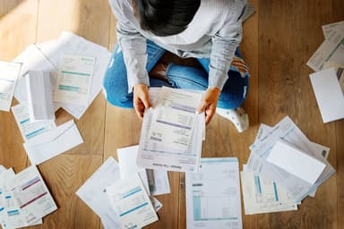 Woman with a lot of bills to pay