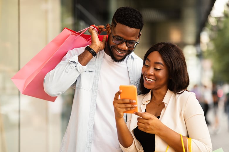 woman and man shopping and looking at phone
