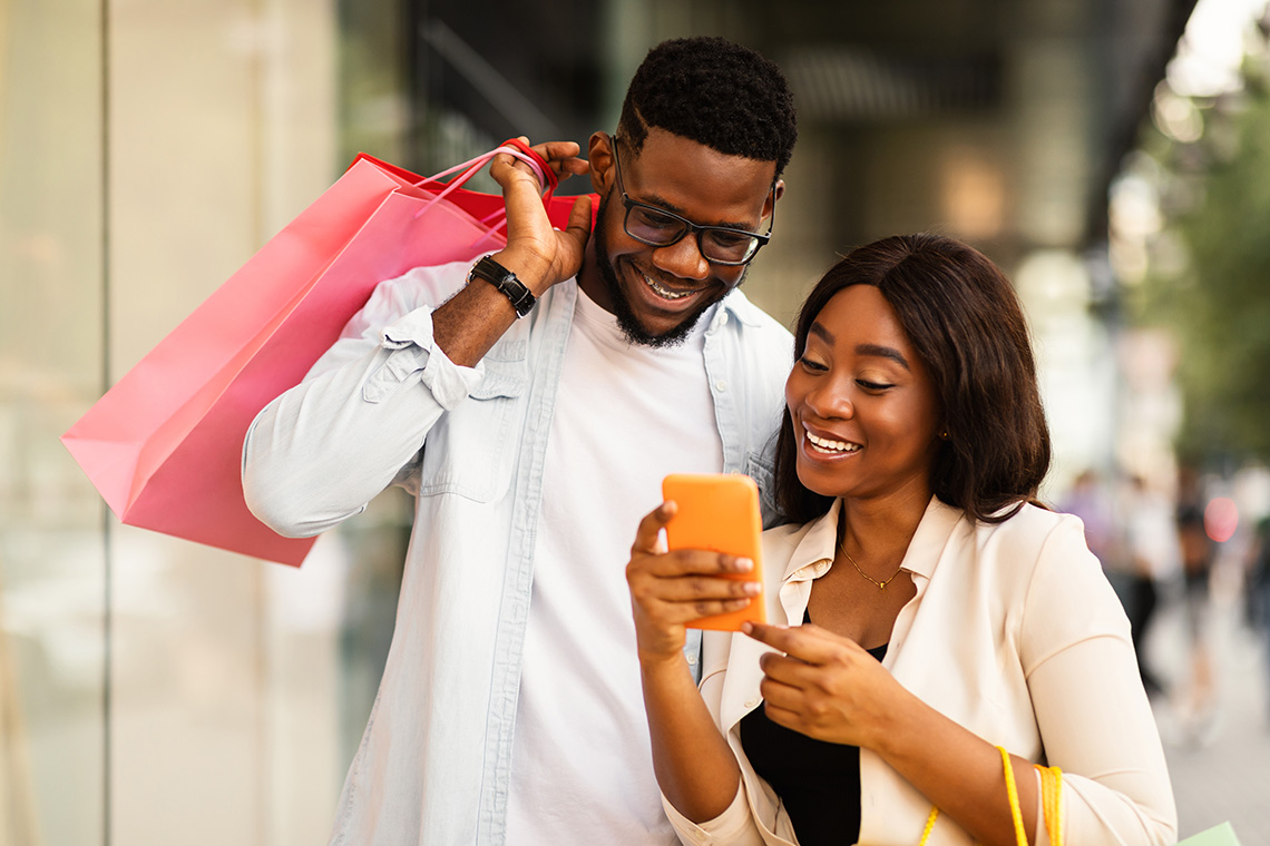 woman and man shopping and looking at phone